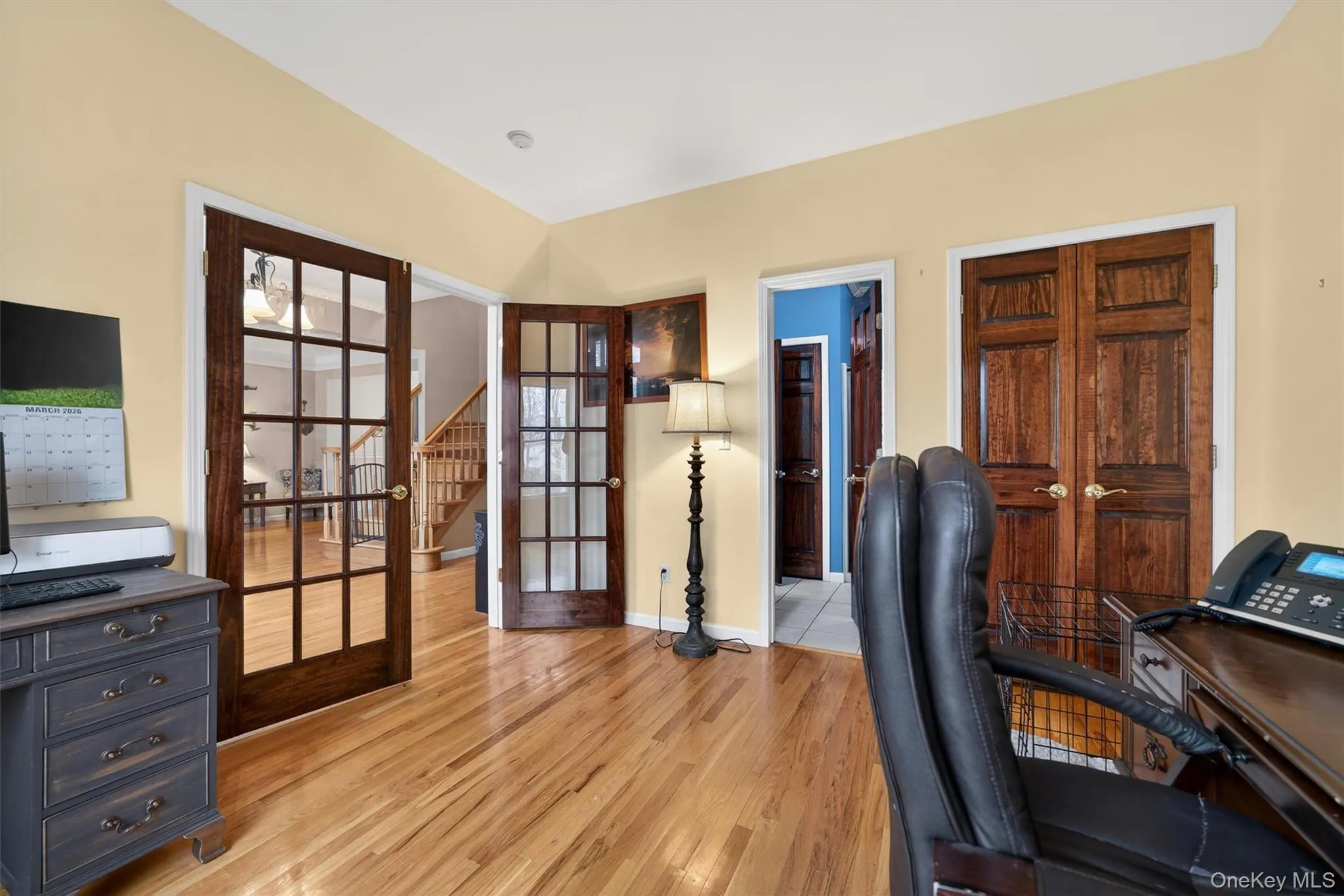 Office area featuring light wood finished floors and french doors Office area featuring light wood finished floors and french doors