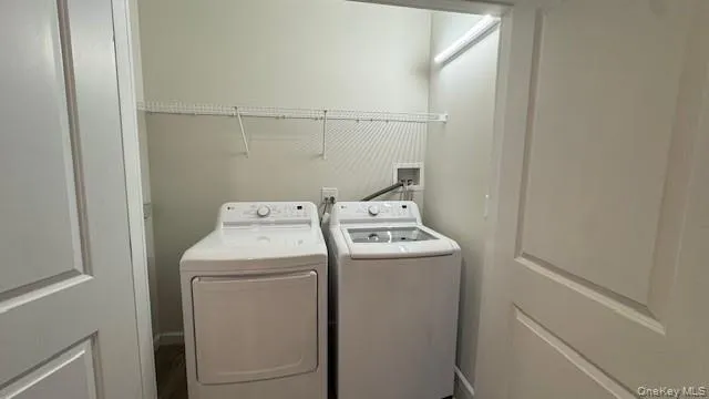 Washroom with washer and clothes dryer Washroom with washer and clothes dryer