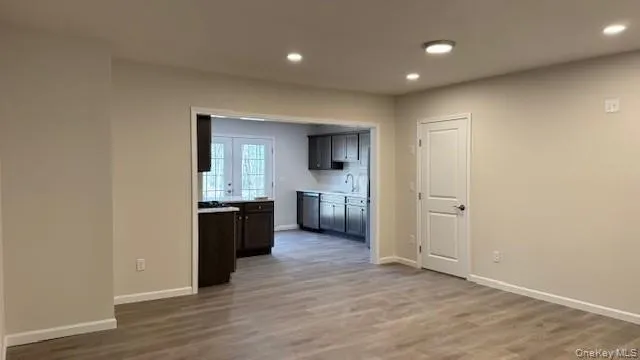 Kitchen featuring dishwasher, light wood-type flooring, and sink Kitchen featuring dishwasher, light wood-type flooring, and sink