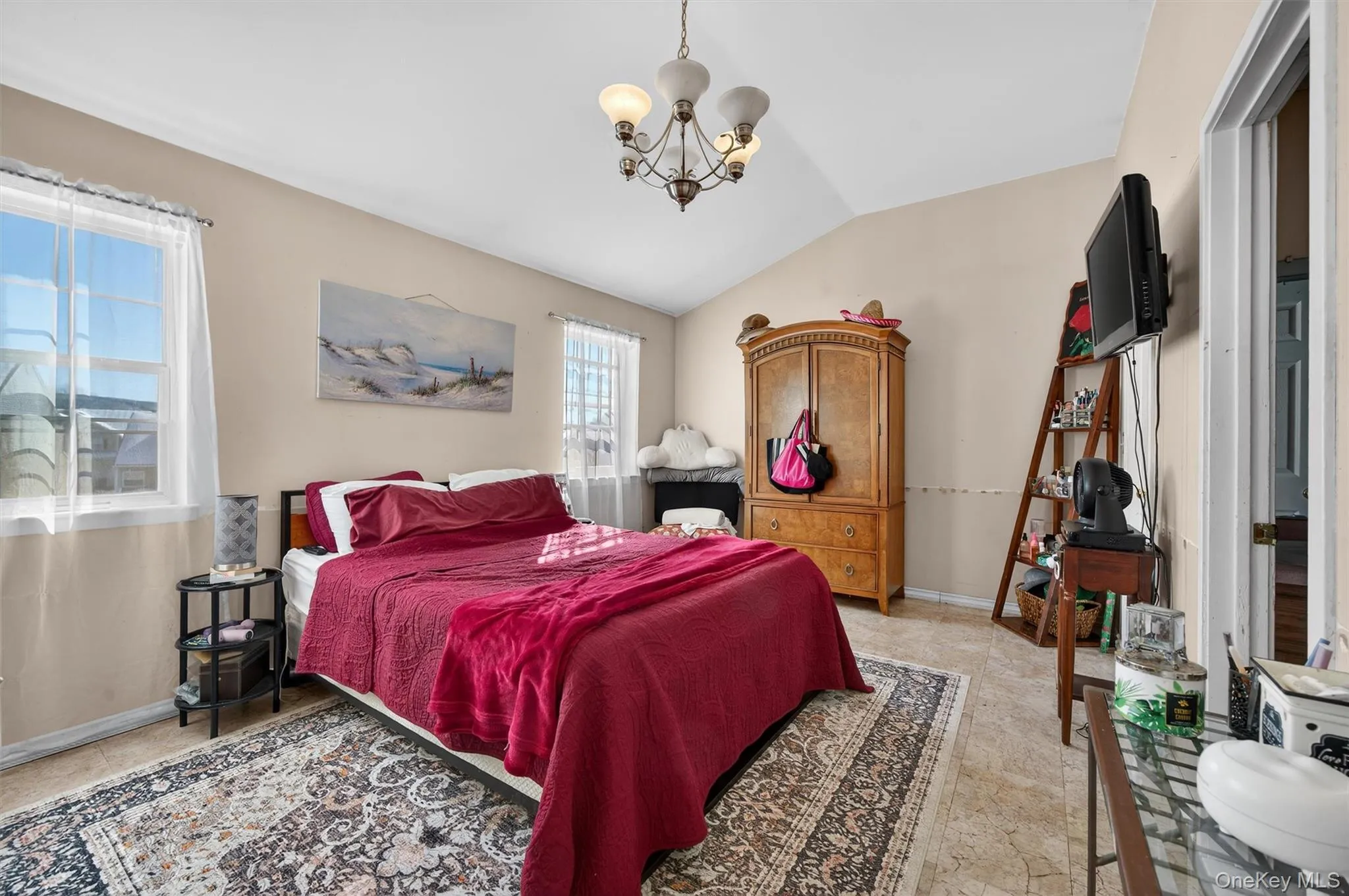 Bedroom featuring a chandelier and lofted ceiling Bedroom featuring a chandelier and lofted ceiling