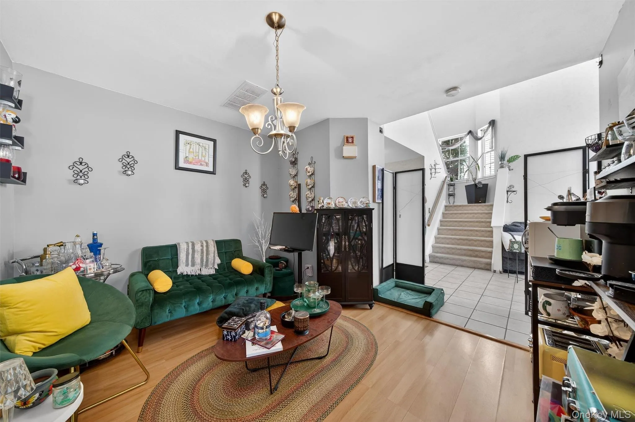 Living room featuring wood finished floors and a chandelier Living room featuring wood finished floors and a chandelier