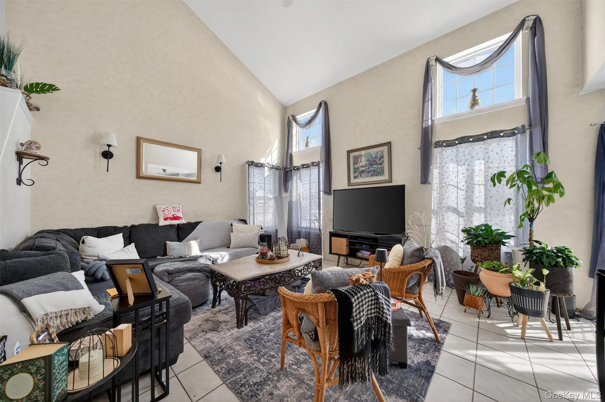 Living room with light tile patterned floors and vaulted ceiling Living room with light tile patterned floors and vaulted ceiling