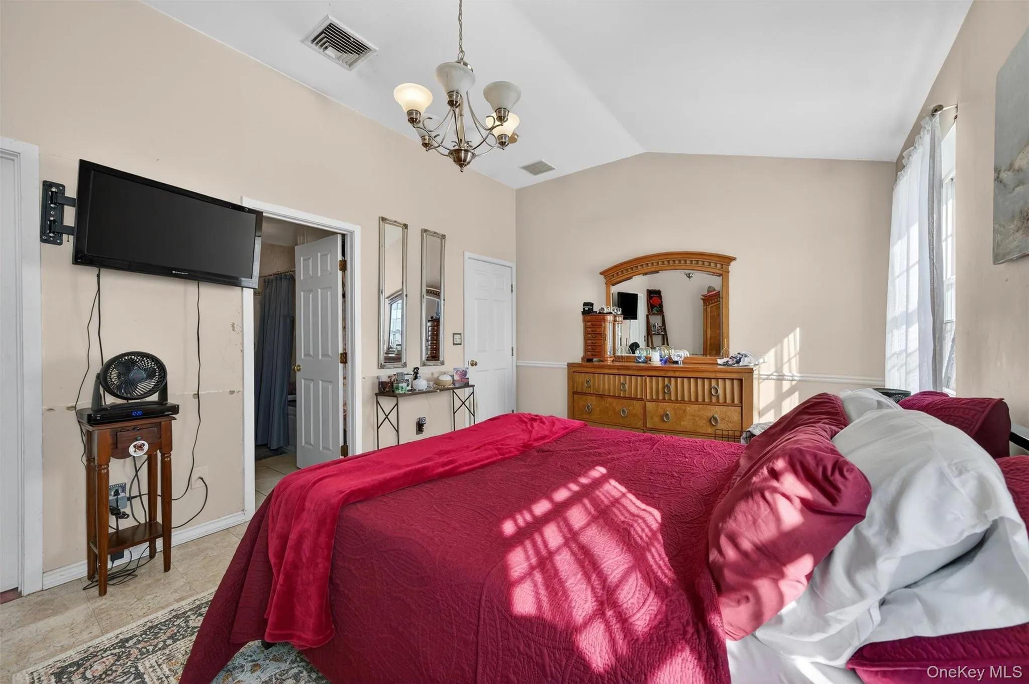 Bedroom with lofted ceiling and suspended lighting Bedroom with lofted ceiling and suspended lighting