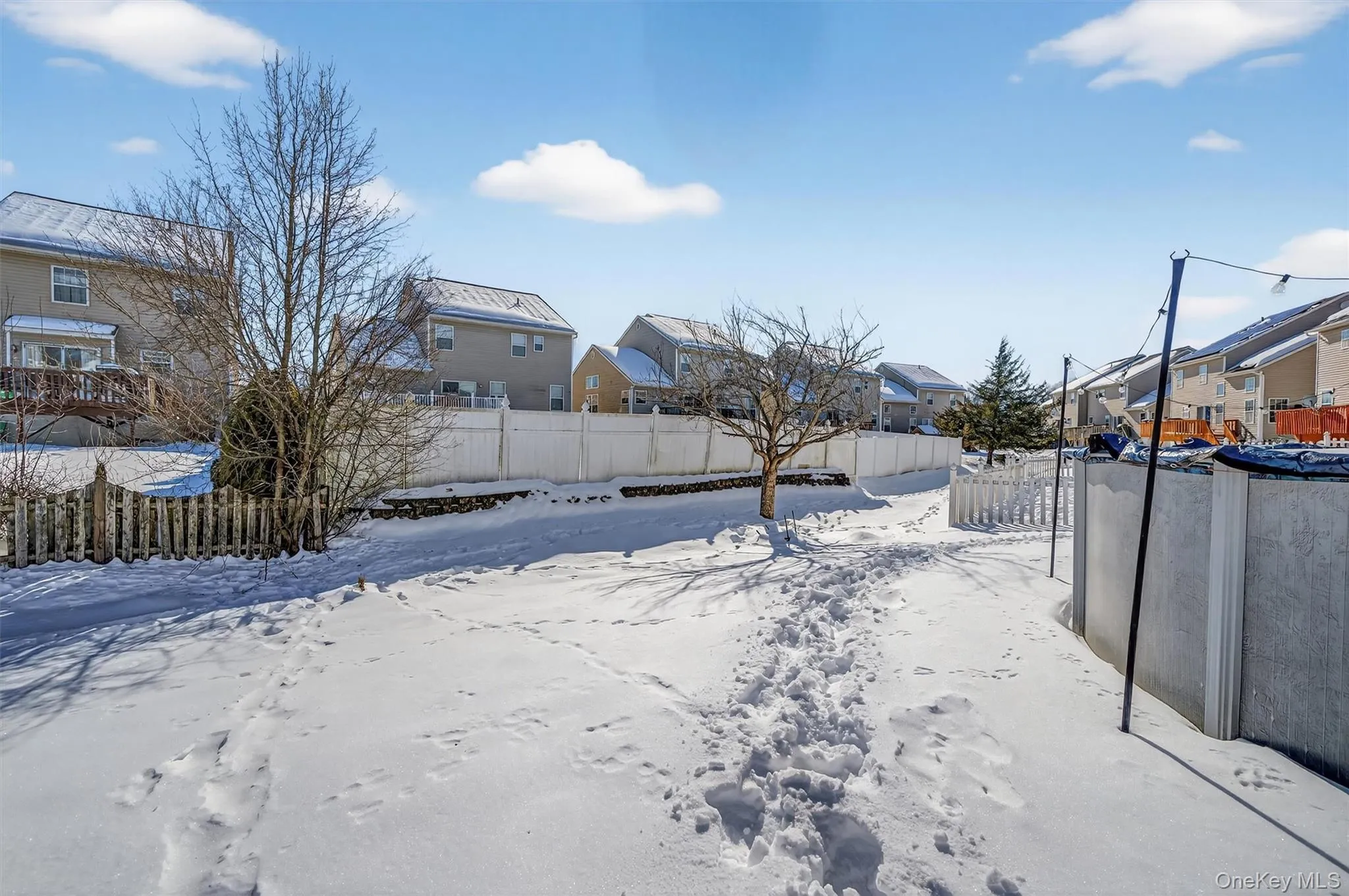 Snowy yard with a residential view Snowy yard with a residential view