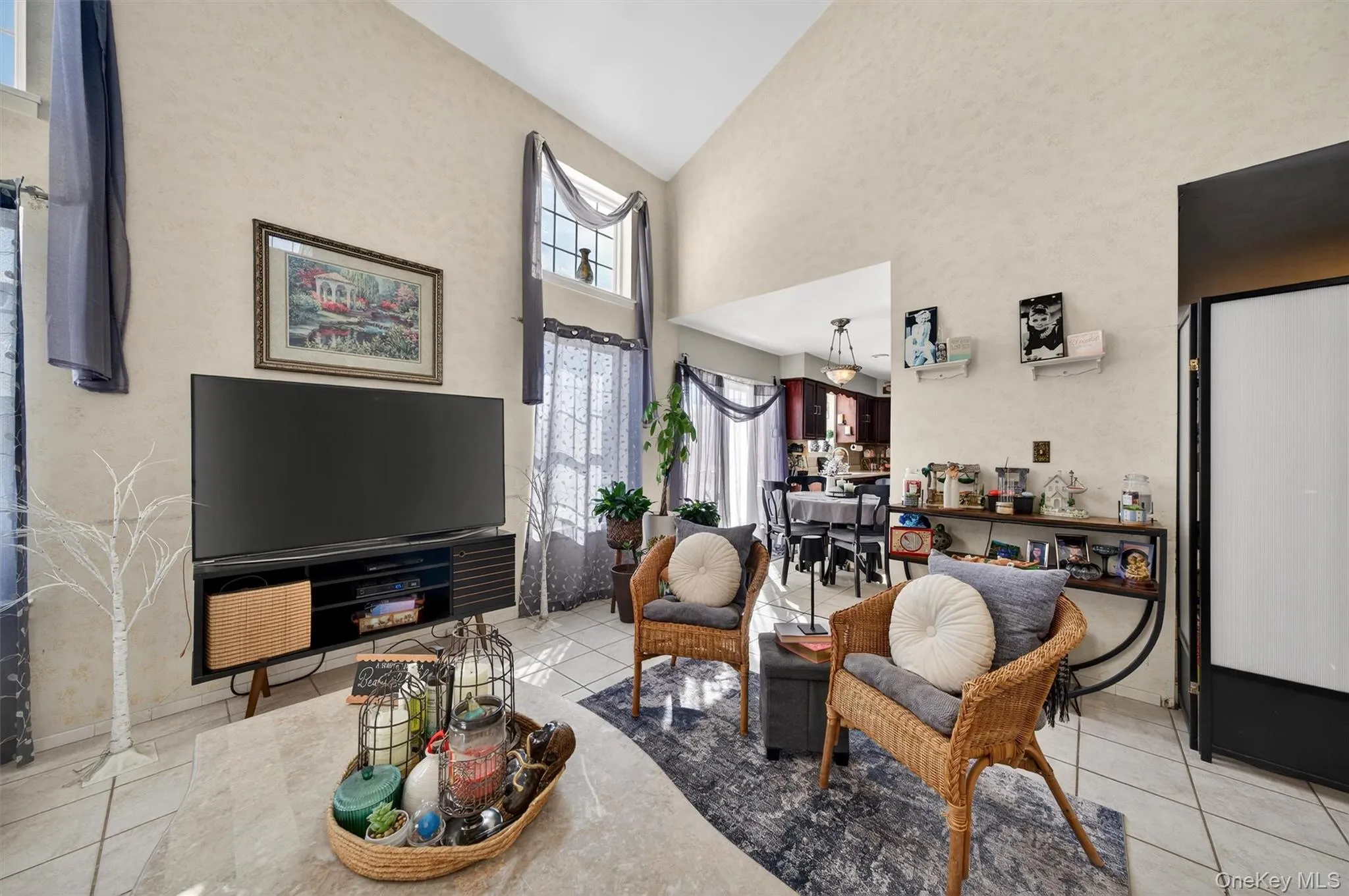 Living area with light tile patterned floors and vaulted ceiling Living area with light tile patterned floors and vaulted ceiling