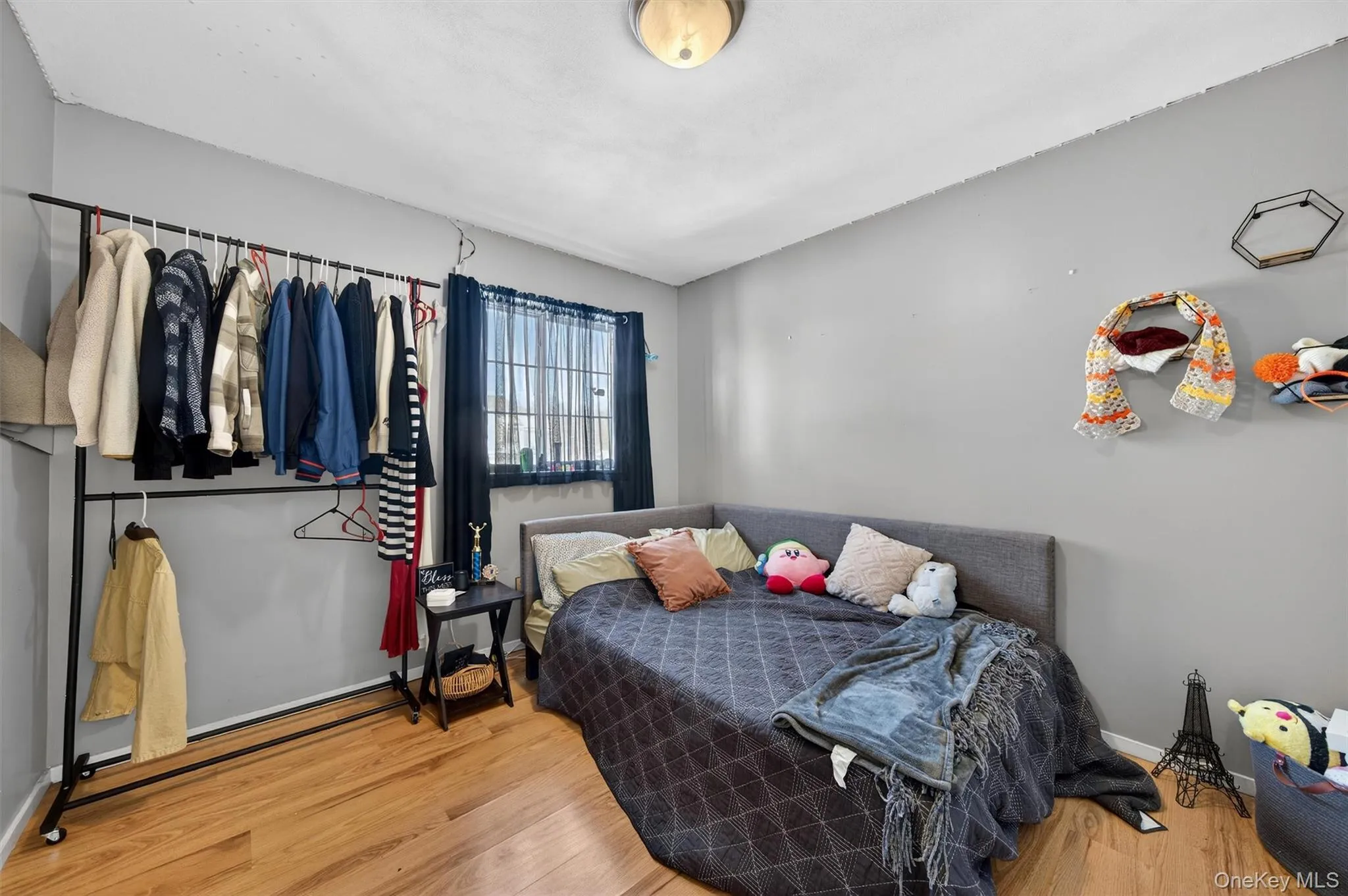 Bedroom featuring wood finished floors and baseboards Bedroom featuring wood finished floors and baseboards