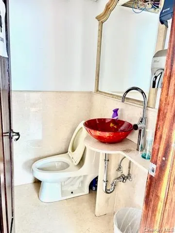 Bathroom with wainscoting and a sink Bathroom with wainscoting and a sink