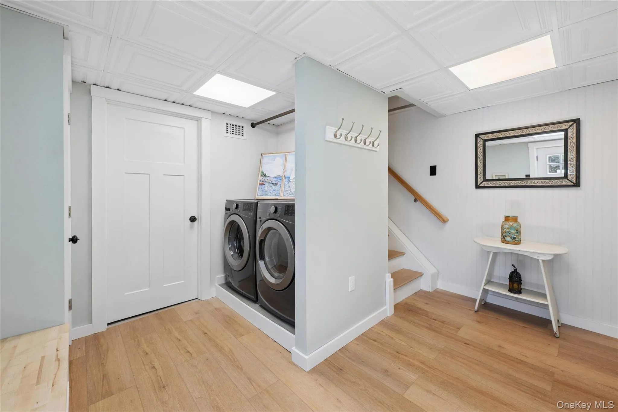 large entry with common laundry area and stairs to main level large entry with common laundry area and stairs to main level