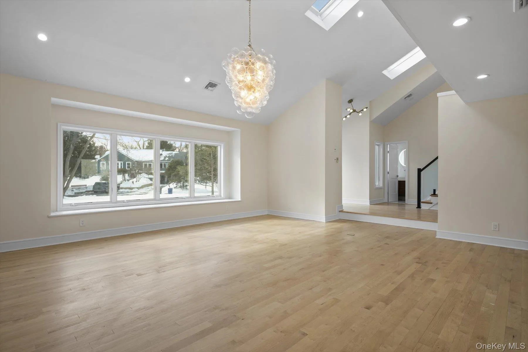 Formal living room with open floor plan, cathedral ceilings and waterviews Formal living room with open floor plan, cathedral ceilings and waterviews