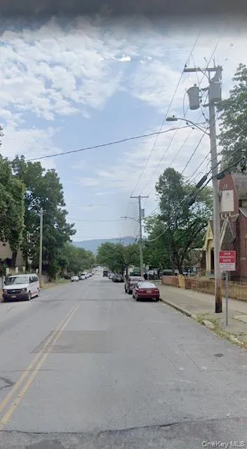 View of asphalt street with sidewalks, street lighting, and curbs View of asphalt street with sidewalks, street lighting, and curbs