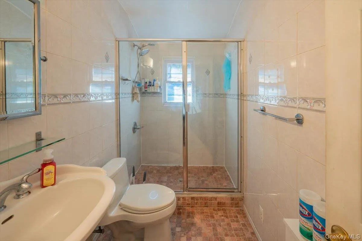 Full bath with tile walls and a shower stall Full bath with tile walls and a shower stall