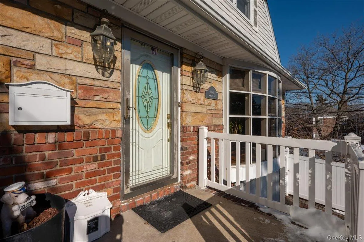 View of exterior entry featuring brick siding and stone siding View of exterior entry featuring brick siding and stone siding