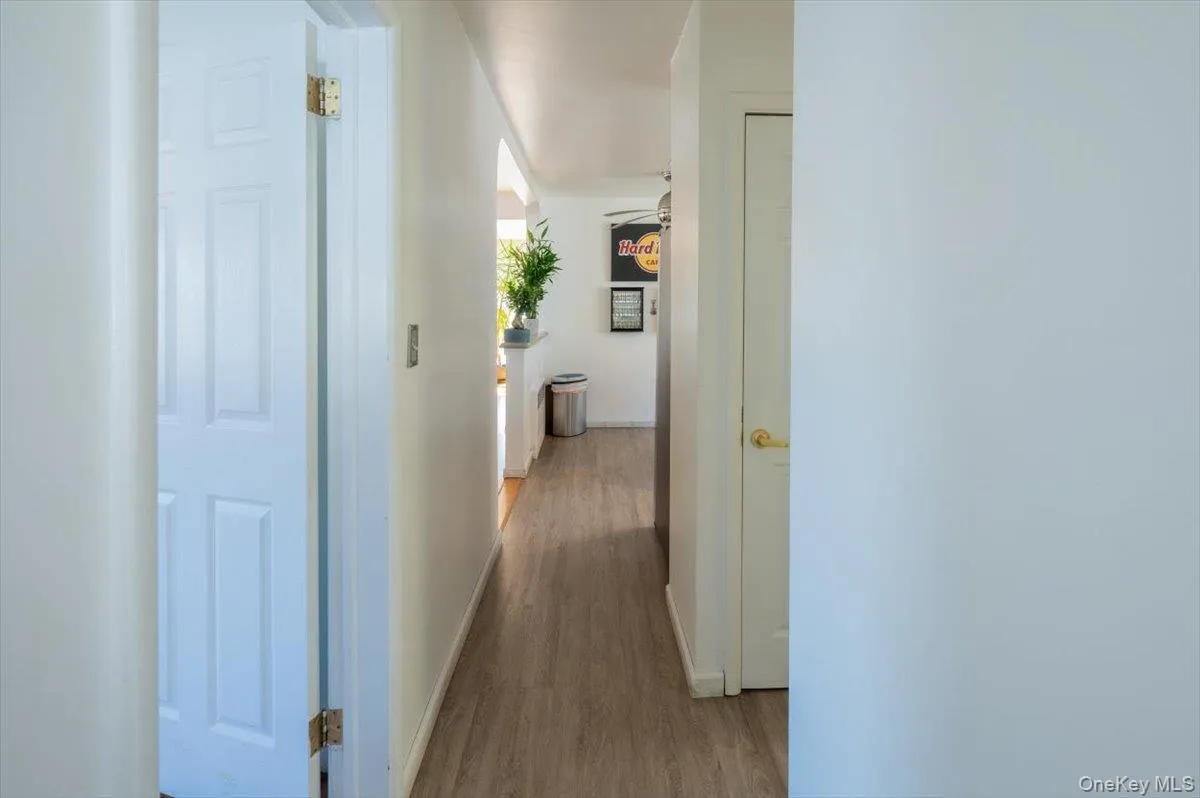 Corridor featuring wood finished floors Corridor featuring wood finished floors