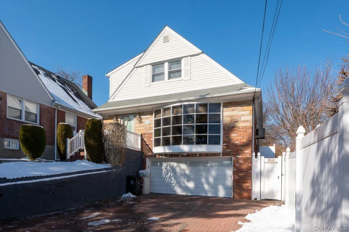View of front of home with an attached garage, decorative driveway, and brick siding View of front of home with an attached garage, decorative driveway, and brick siding