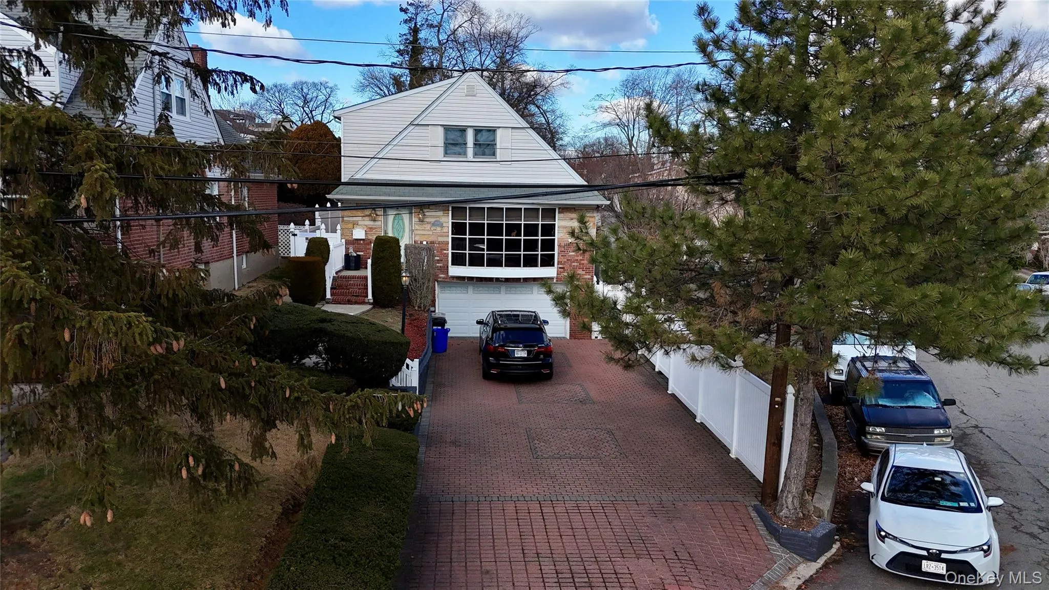 View of front of property with decorative driveway and a garage View of front of property with decorative driveway and a garage