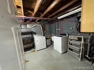 Unfinished below grade area with washer and clothes dryer Unfinished below grade area with washer and clothes dryer