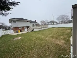 View of yard featuring a deck and a fenced backyard View of yard featuring a deck and a fenced backyard