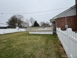 View of yard featuring a fenced backyard and a wooden deck View of yard featuring a fenced backyard and a wooden deck