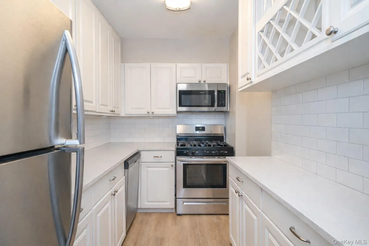 Updated Kitchen with hard wood floors, stainless steel appliances, coffee bar and bright white cabinetry. Updated Kitchen with hard wood floors, stainless steel appliances, coffee bar and bright white cabinetry.