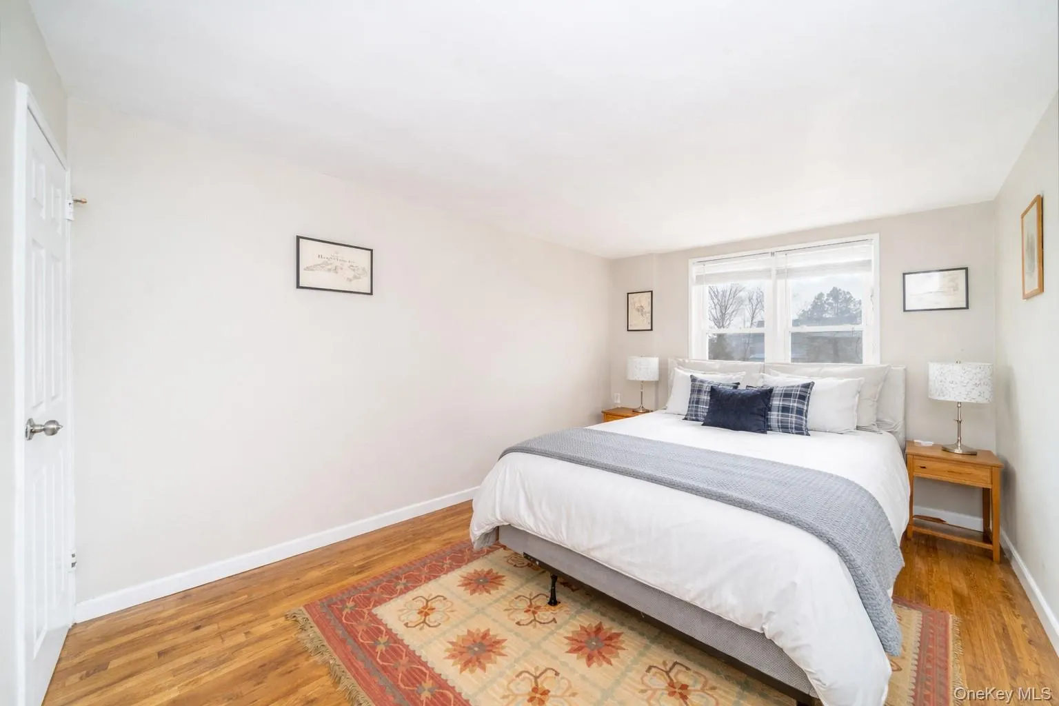 Spacious and sunny bedroom with hardwood floors. Photo has been digitally altered Spacious and sunny bedroom with hardwood floors. Photo has been digitally altered