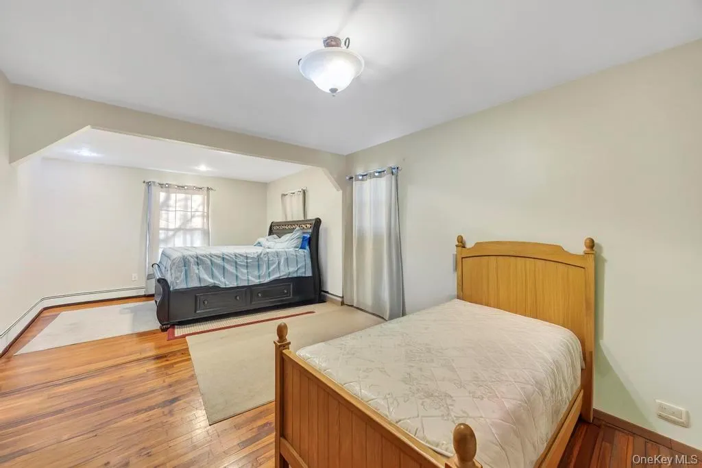 Bedroom with light wood-style flooring and baseboards Bedroom with light wood-style flooring and baseboards
