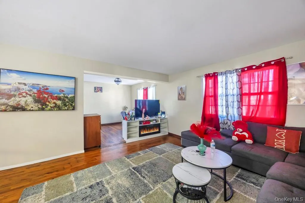 Living room featuring wood finished floors and a fireplace Living room featuring wood finished floors and a fireplace
