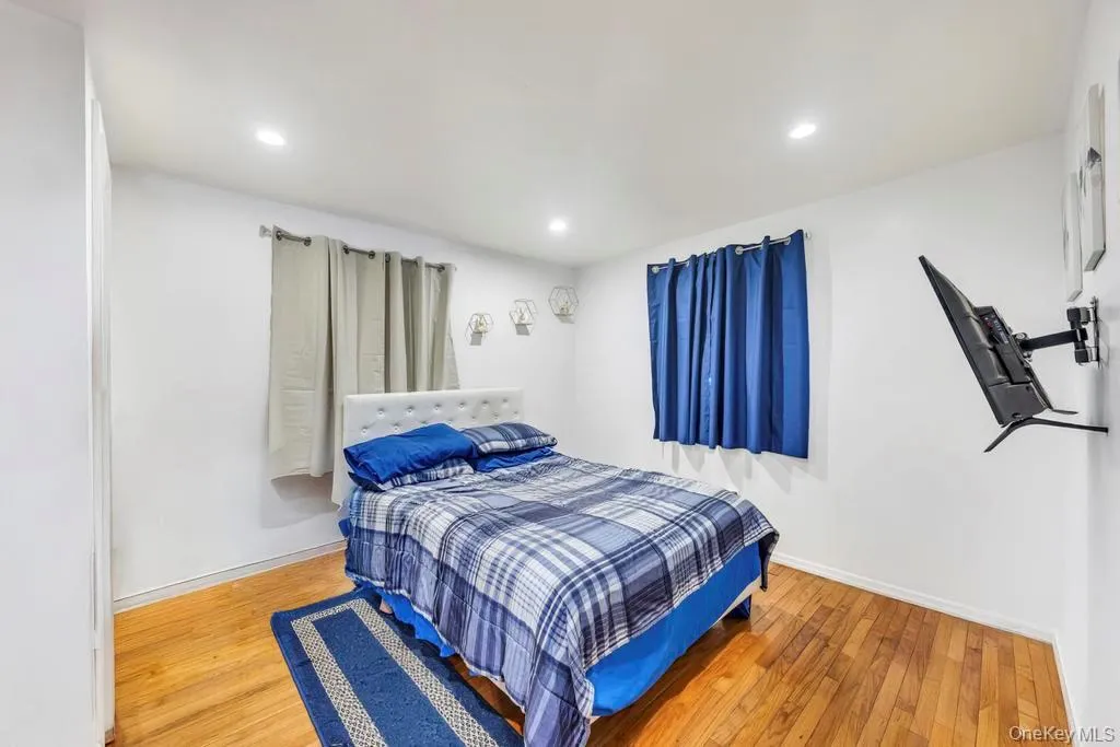 Bedroom featuring light wood finished floors and recessed lighting Bedroom featuring light wood finished floors and recessed lighting