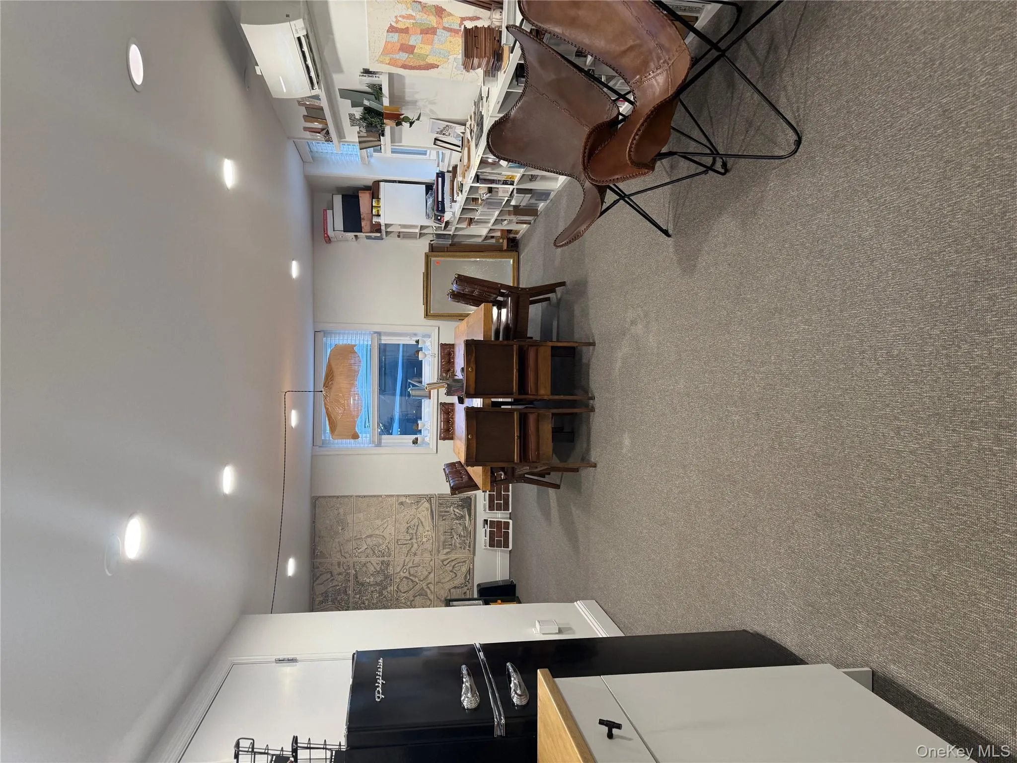 Large room currently set up as a conference room with a kitchenette area Large room currently set up as a conference room with a kitchenette area