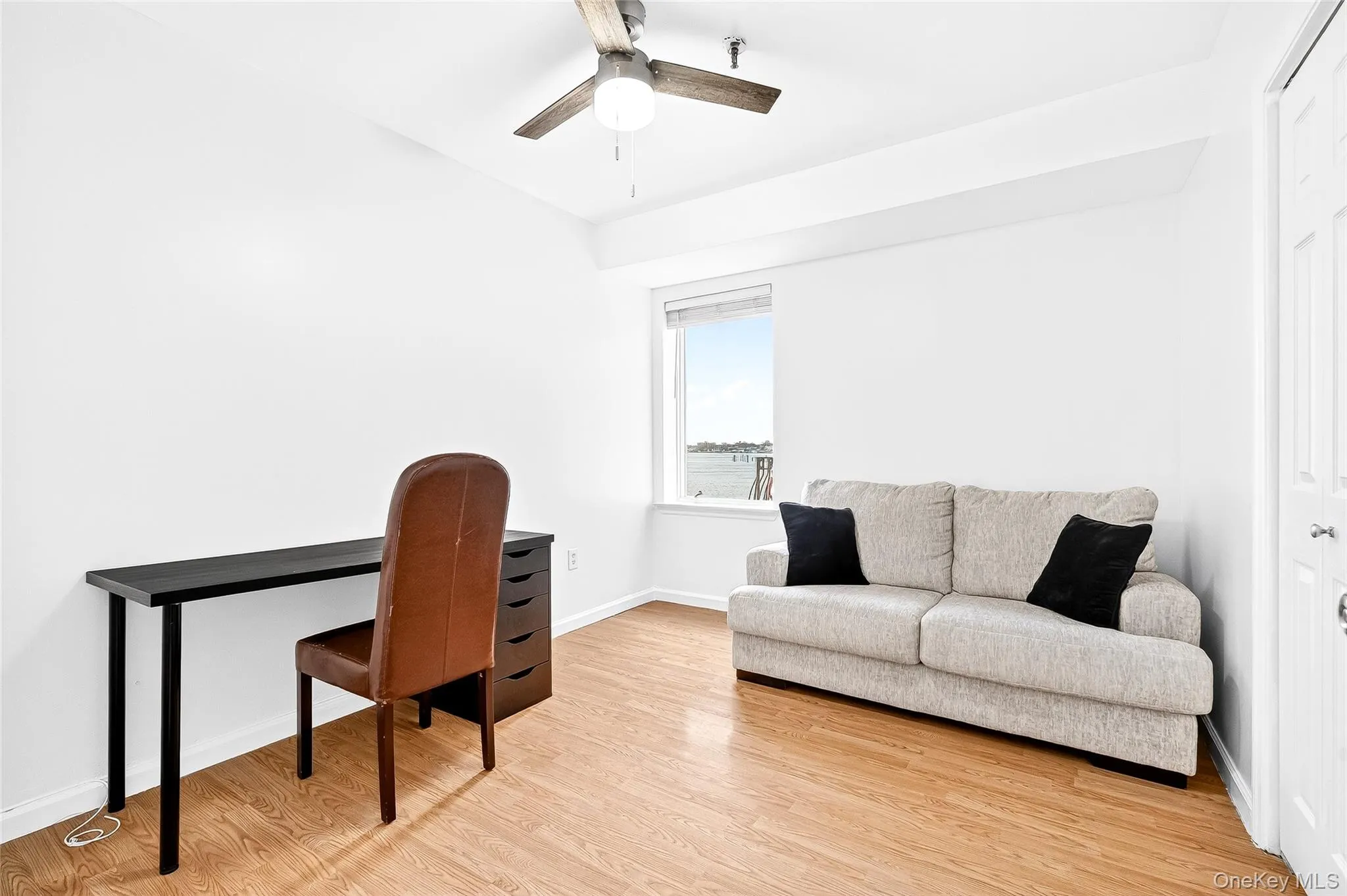 Third bedroom/office area with light wood finished floors and ceiling fan Third bedroom/office area with light wood finished floors and ceiling fan