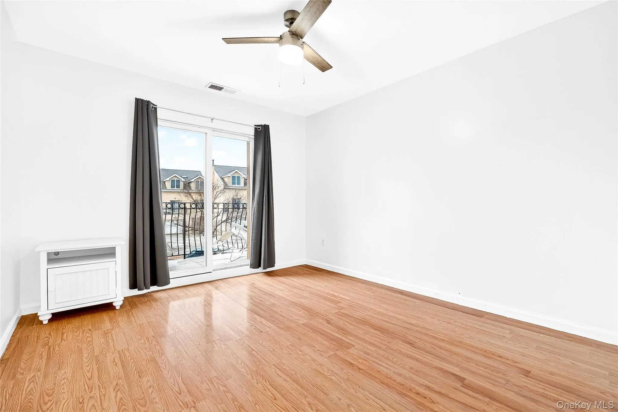 Second bedroom balcony access view front of building; courtyard, parking area, some water view. Second bedroom balcony access view front of building; courtyard, parking area, some water view.