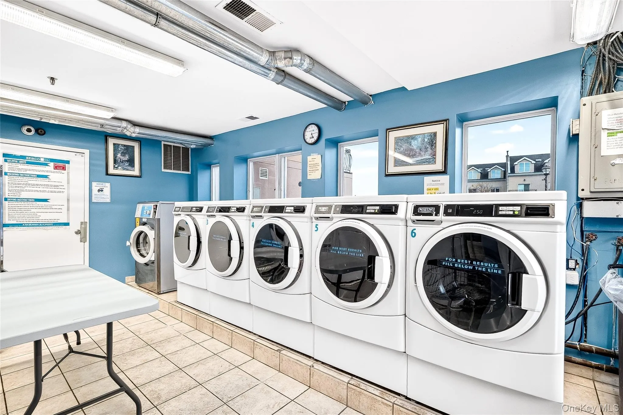 Shared laundry room with and washing machines and dryers, ample room. Shared laundry room with and washing machines and dryers, ample room.