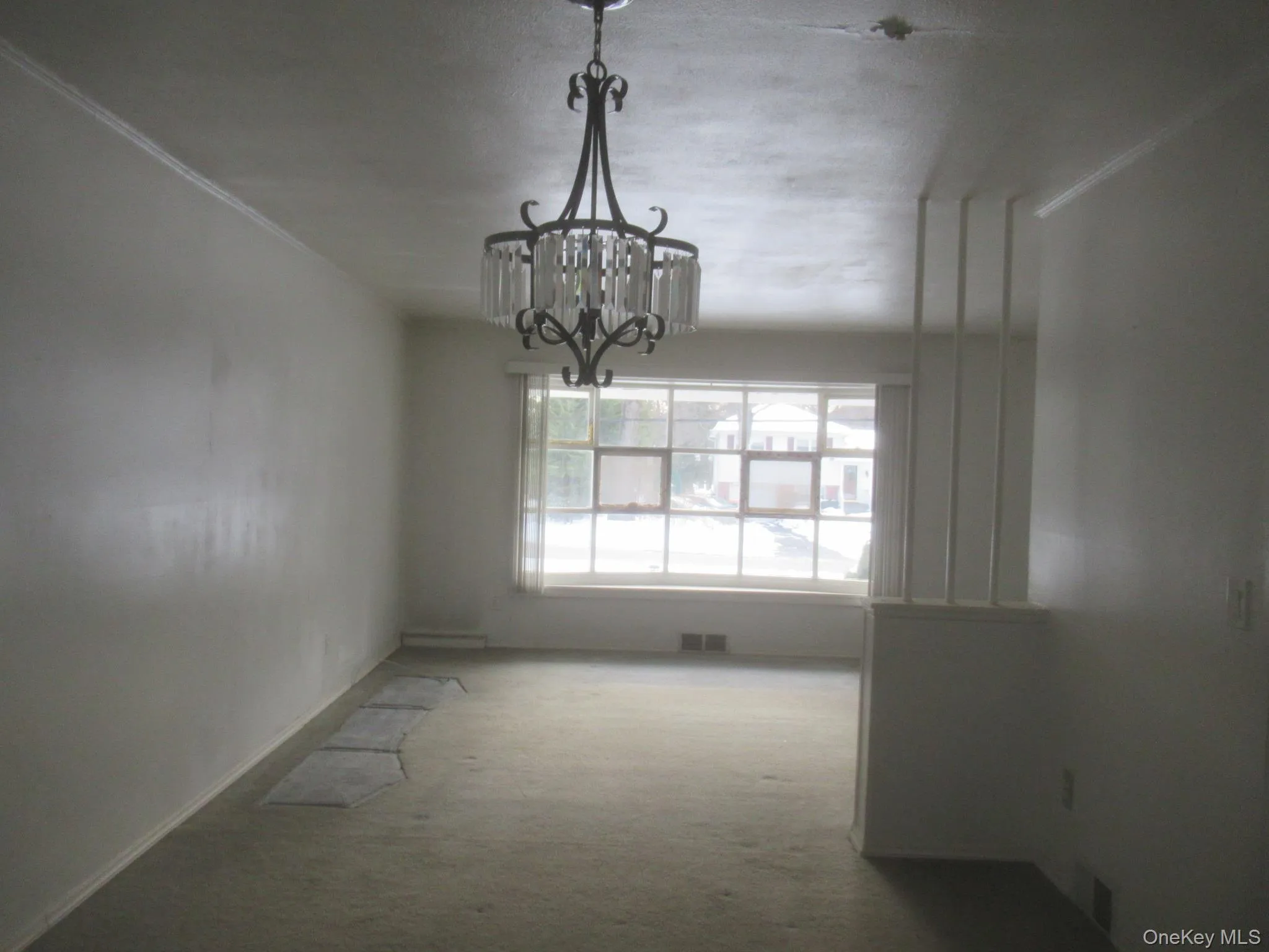 Unfurnished dining area featuring a chandelier and carpet floors Unfurnished dining area featuring a chandelier and carpet floors