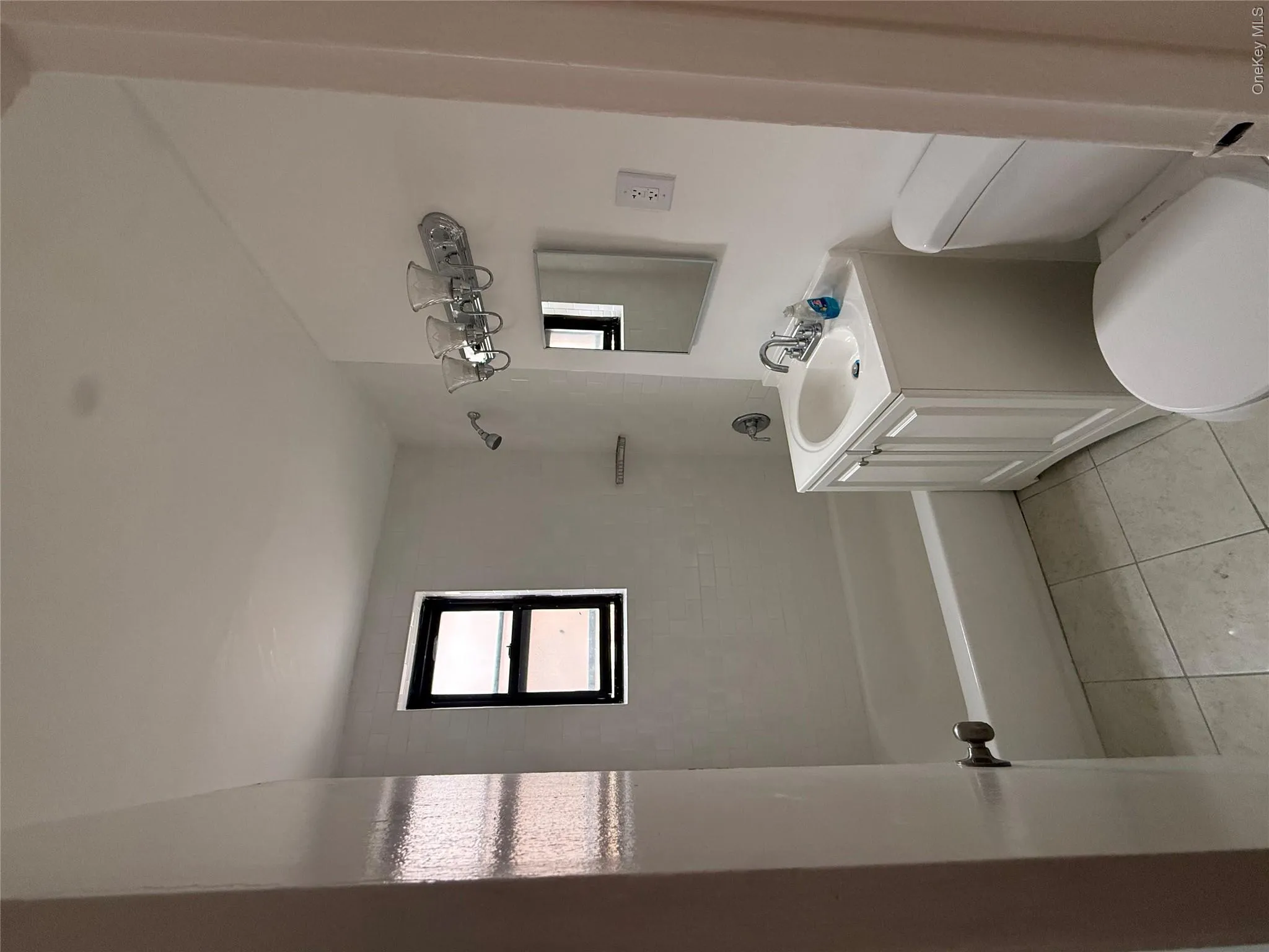 Full bath featuring vanity, shower / bath combination, and light tile patterned floors Full bath featuring vanity, shower / bath combination, and light tile patterned floors