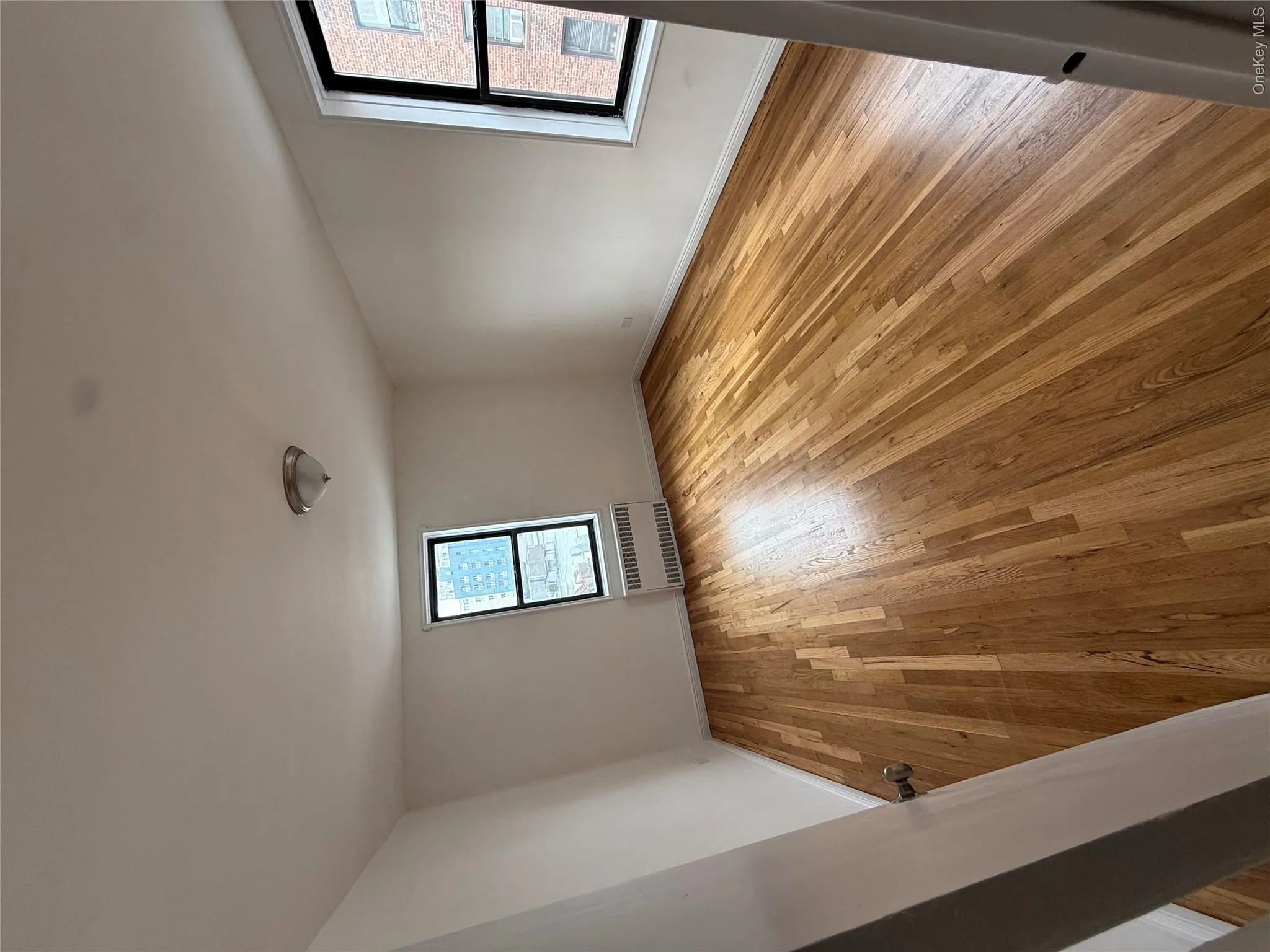 Bedroom with light wood flooring and radiator Bedroom with light wood flooring and radiator