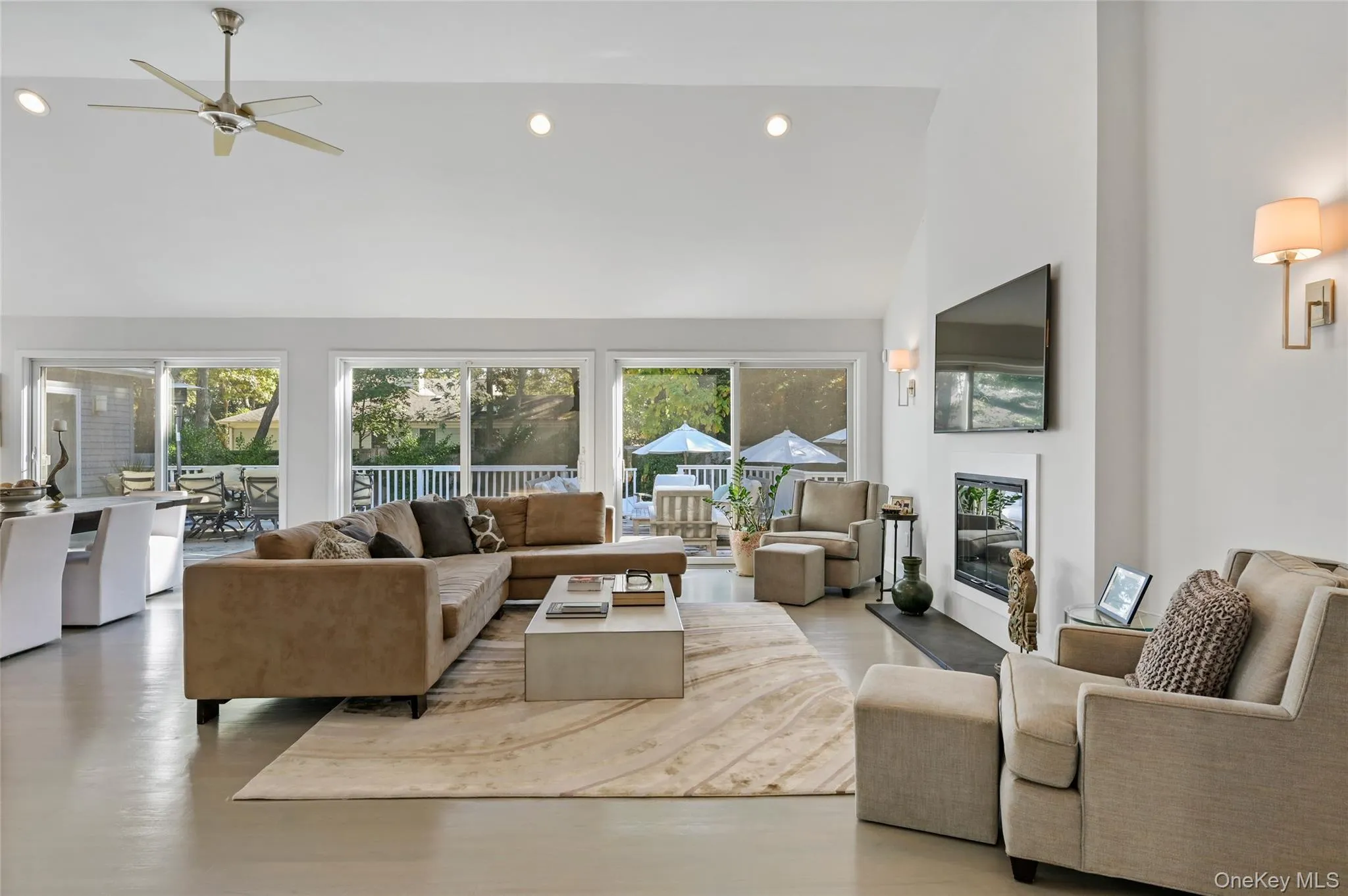 Living room with ceiling fan and high vaulted ceiling Living room with ceiling fan and high vaulted ceiling