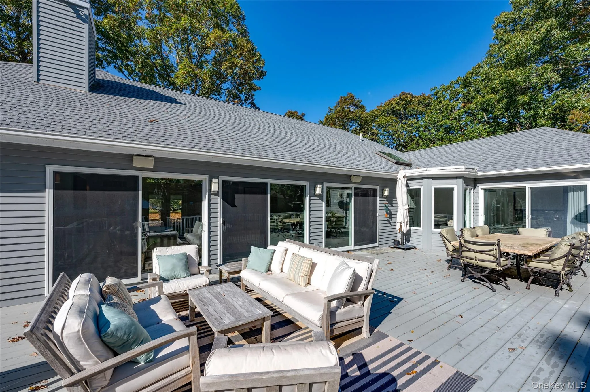Wooden terrace featuring an outdoor hangout area Wooden terrace featuring an outdoor hangout area