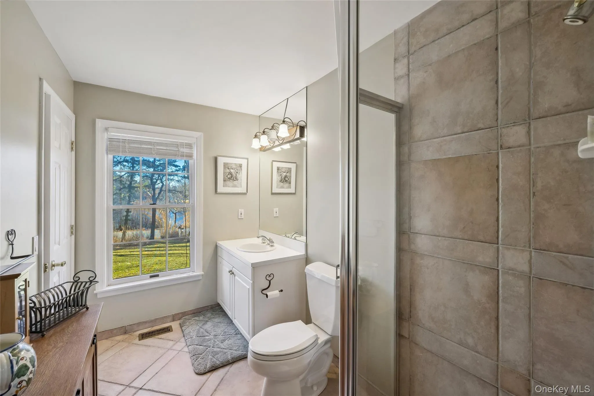 Full bathroom with toilet, visible vents, a notable chandelier, tile patterned flooring, and vanity Full bathroom with toilet, visible vents, a notable chandelier, tile patterned flooring, and vanity