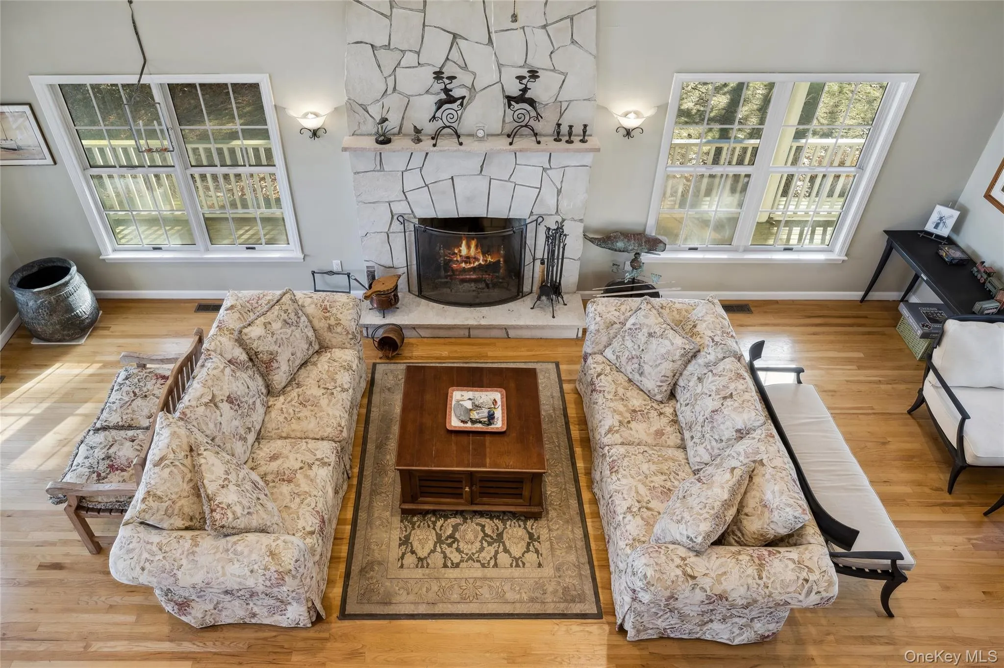 Living room featuring a fireplace, wood finished floors, and baseboards Living room featuring a fireplace, wood finished floors, and baseboards