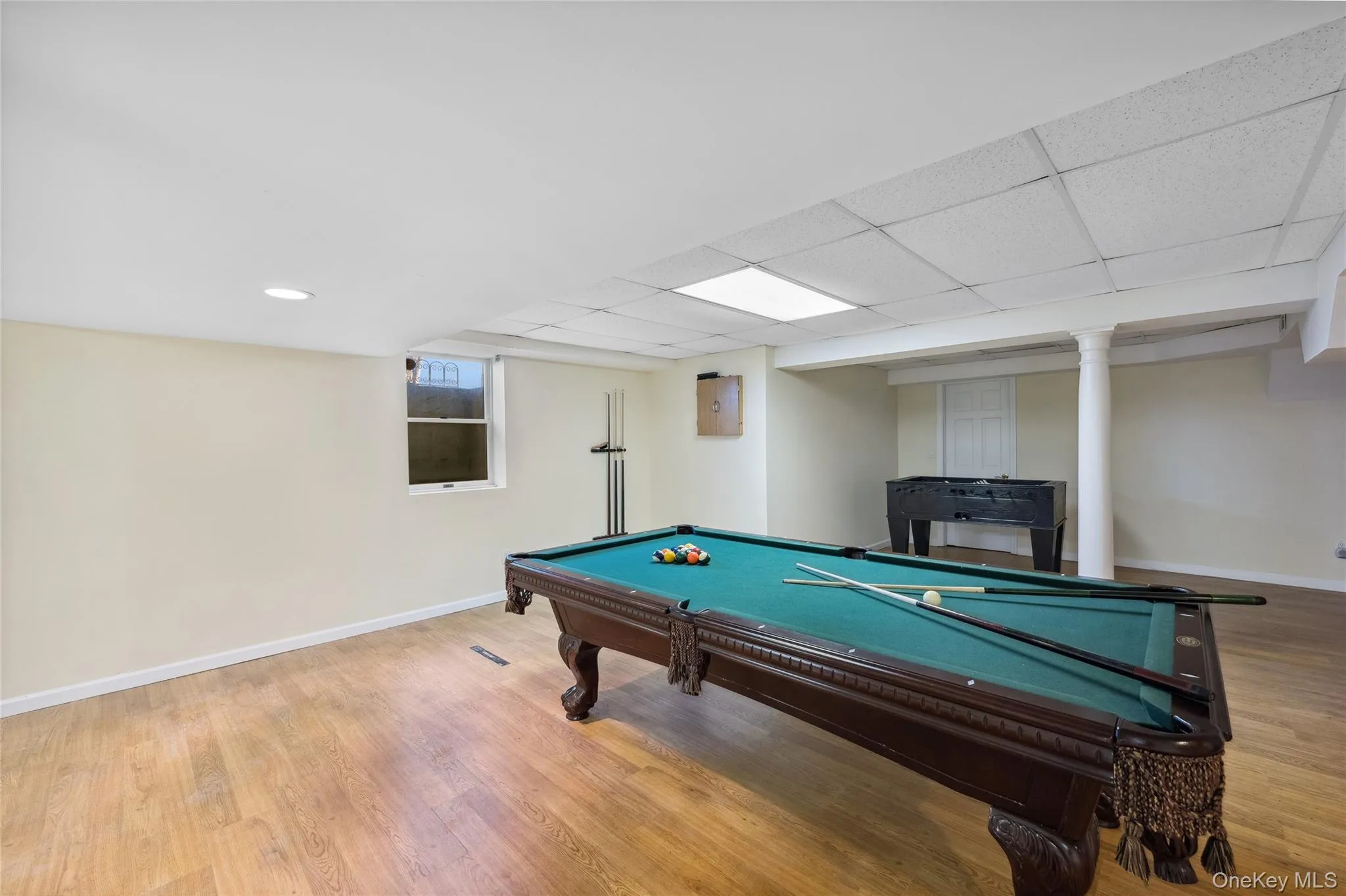Rec room with baseboards, billiards, wood finished floors, and a drop ceiling Rec room with baseboards, billiards, wood finished floors, and a drop ceiling