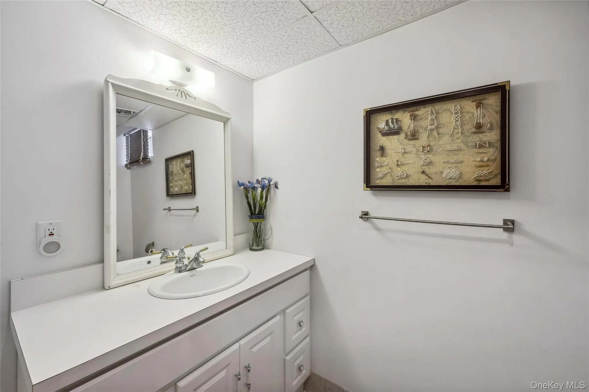 Bathroom with vanity and a paneled ceiling Bathroom with vanity and a paneled ceiling