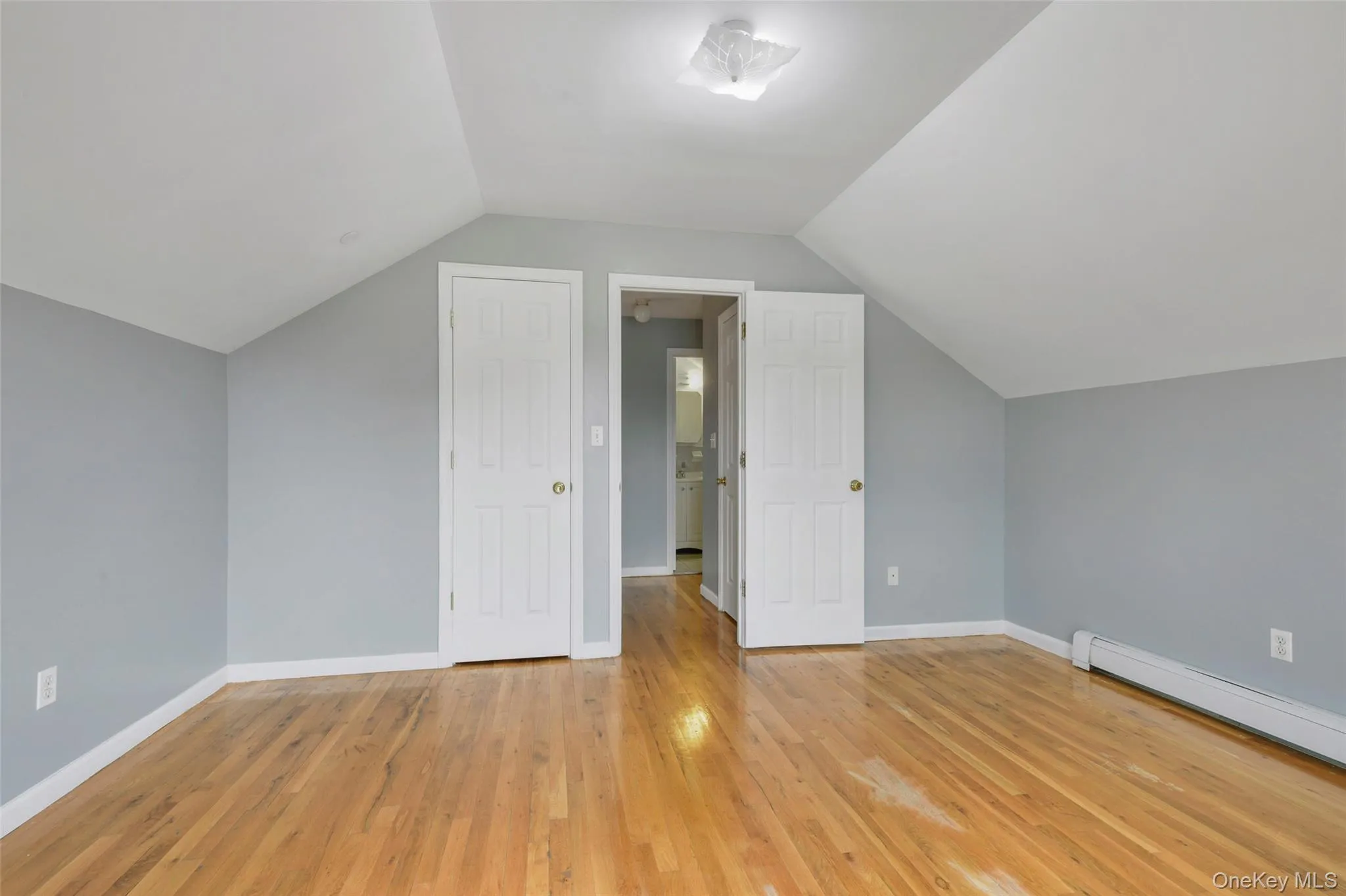View from primary bedroom to closet & hallway with large linen closet & full bathroom. View from primary bedroom to closet & hallway with large linen closet & full bathroom.