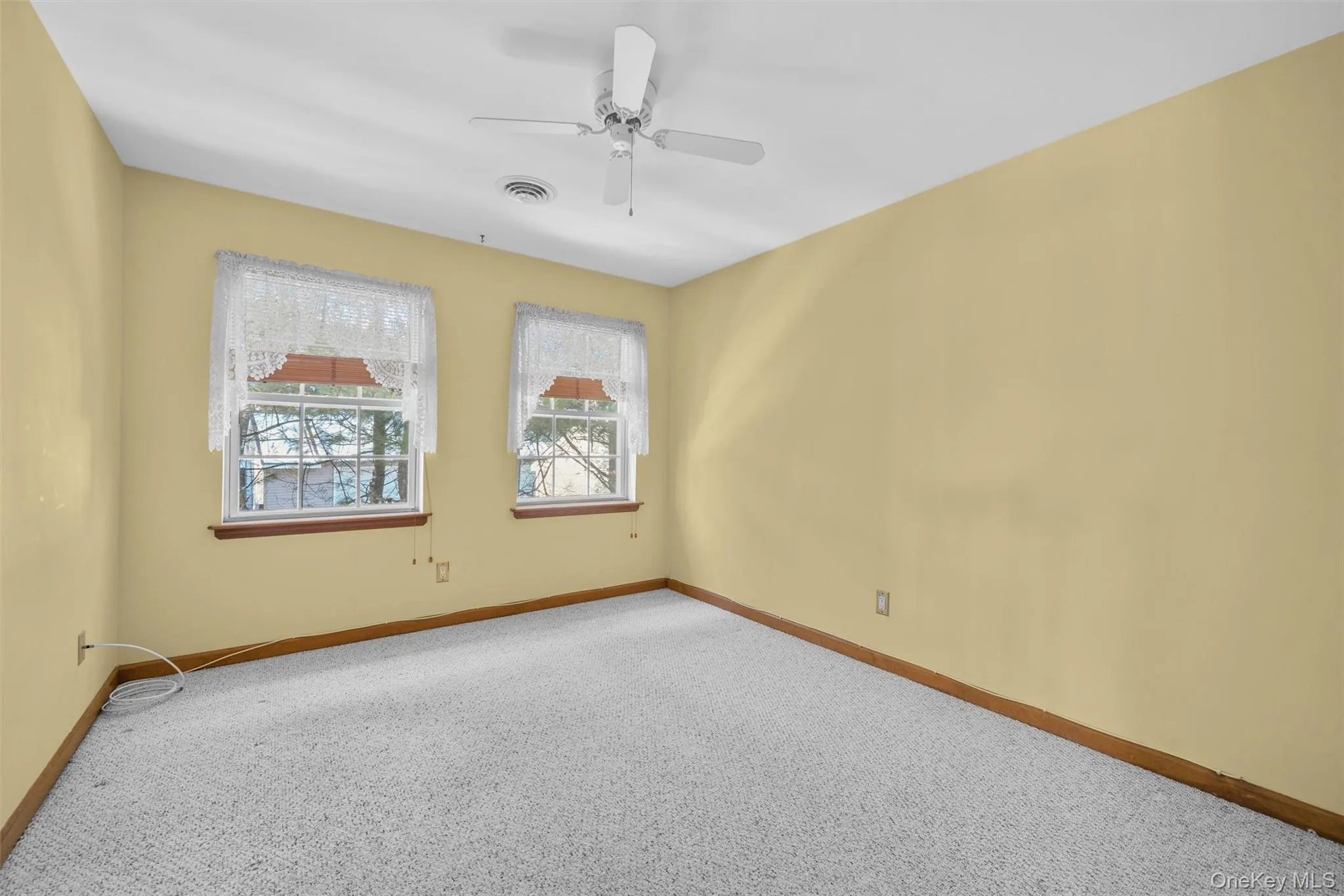 Carpeted second bedroom featuring ceiling fan Carpeted second bedroom featuring ceiling fan