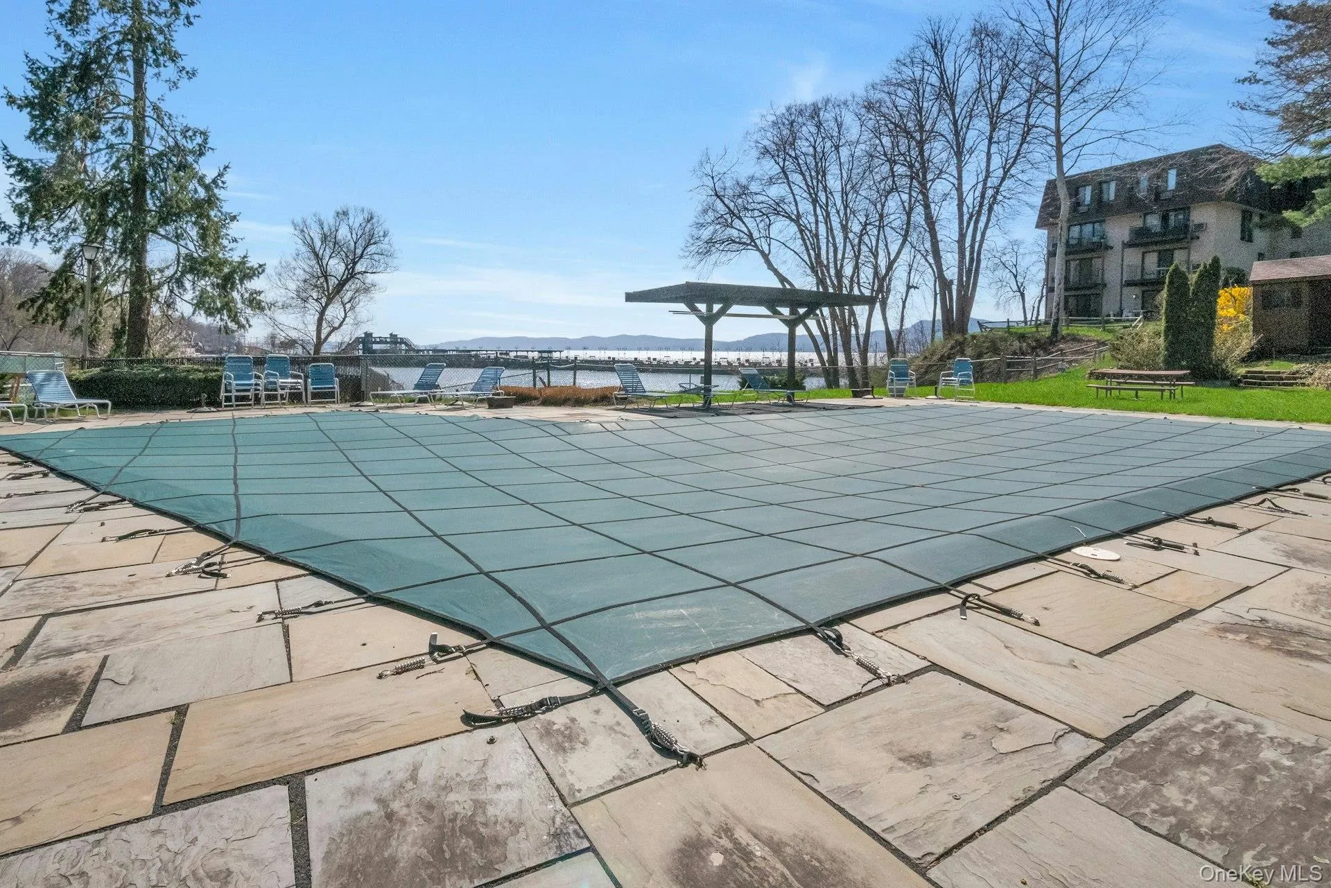 Pool with water views and picnic tables Pool with water views and picnic tables