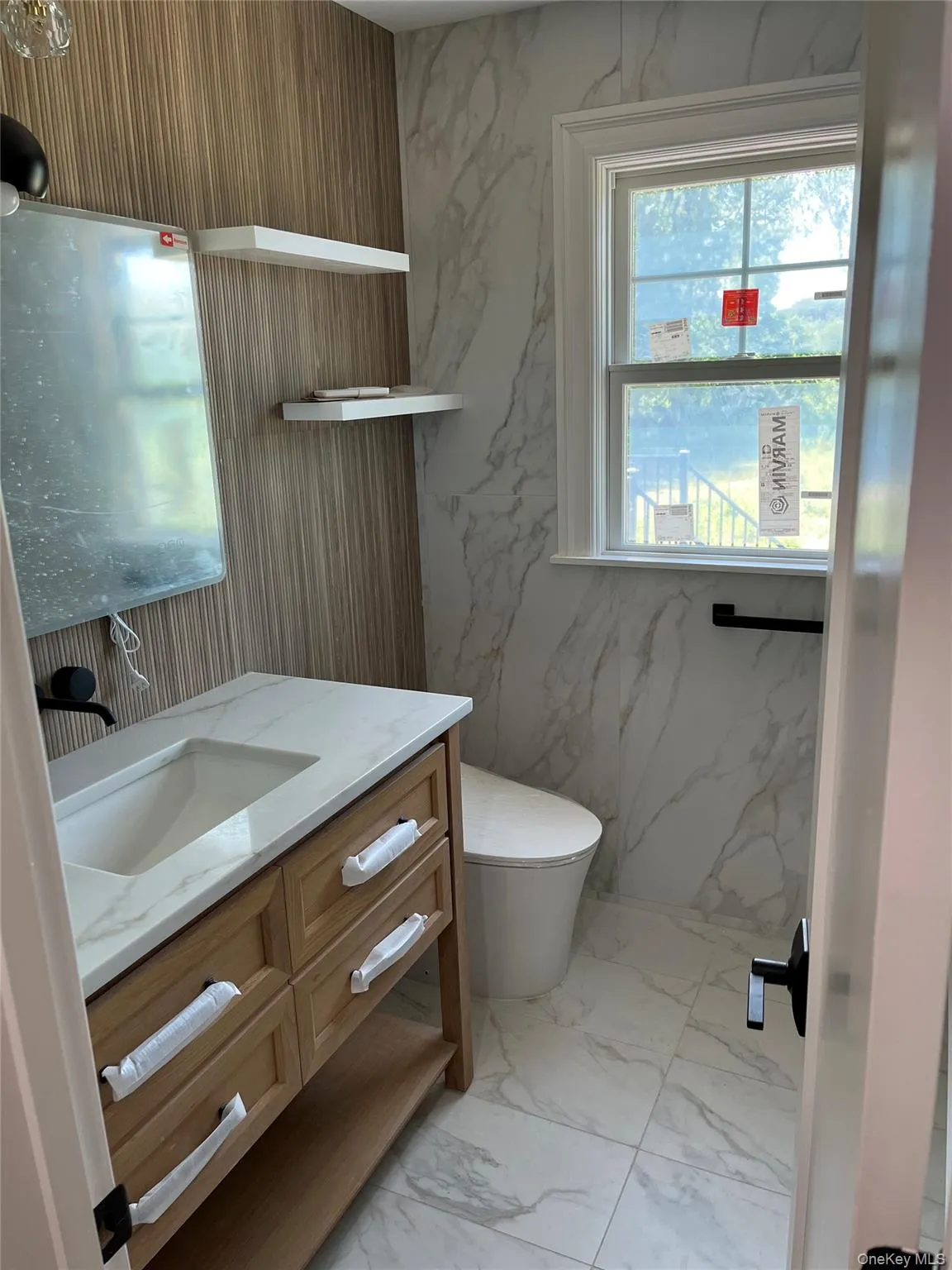 Bathroom featuring marble finish floors and vanity Bathroom featuring marble finish floors and vanity