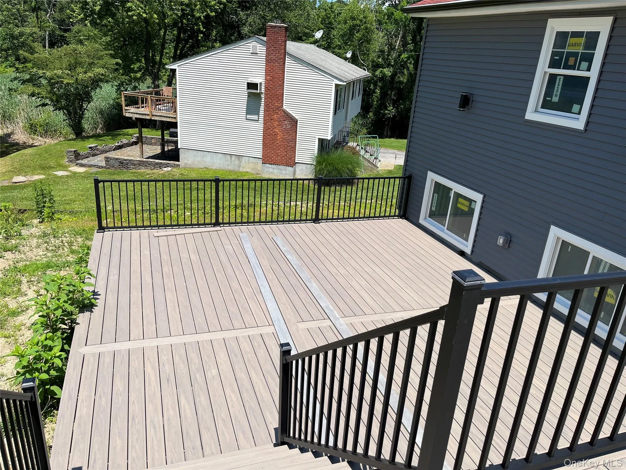 Deck featuring a lawn Deck featuring a lawn