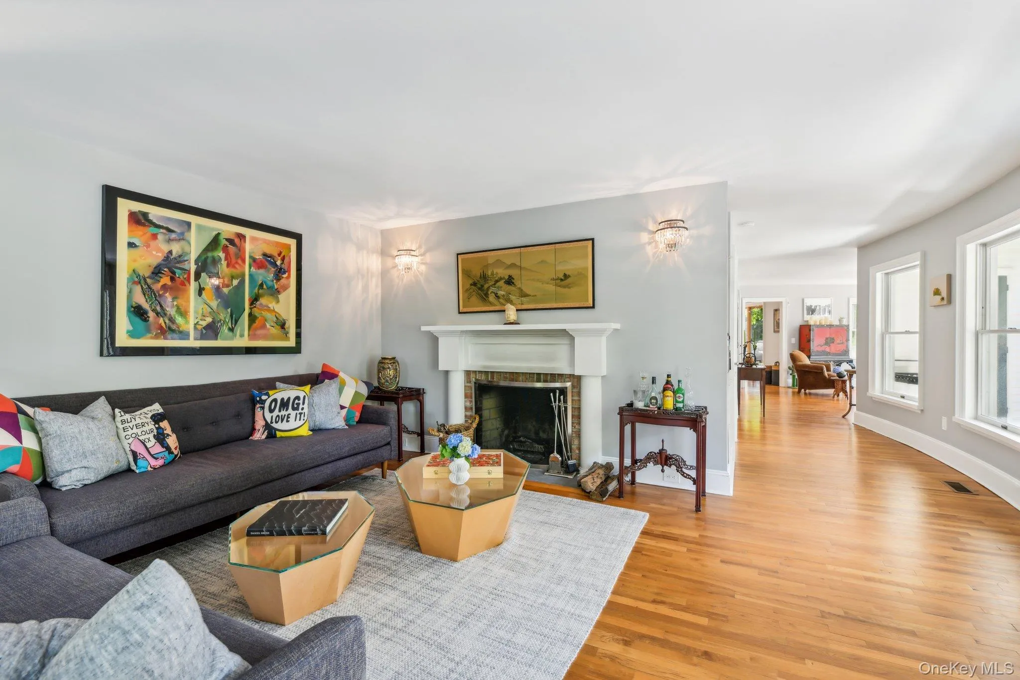 Living room featuring light wood-style flooring and a fireplace Living room featuring light wood-style flooring and a fireplace