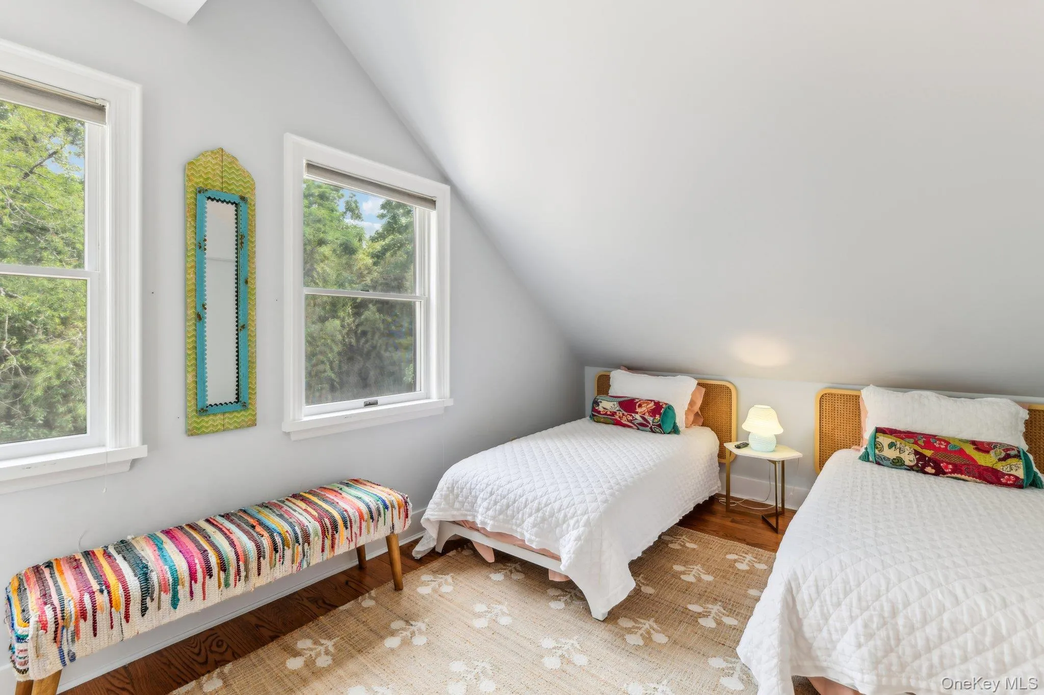 Bedroom with light wood-style flooring and lofted ceiling Bedroom with light wood-style flooring and lofted ceiling