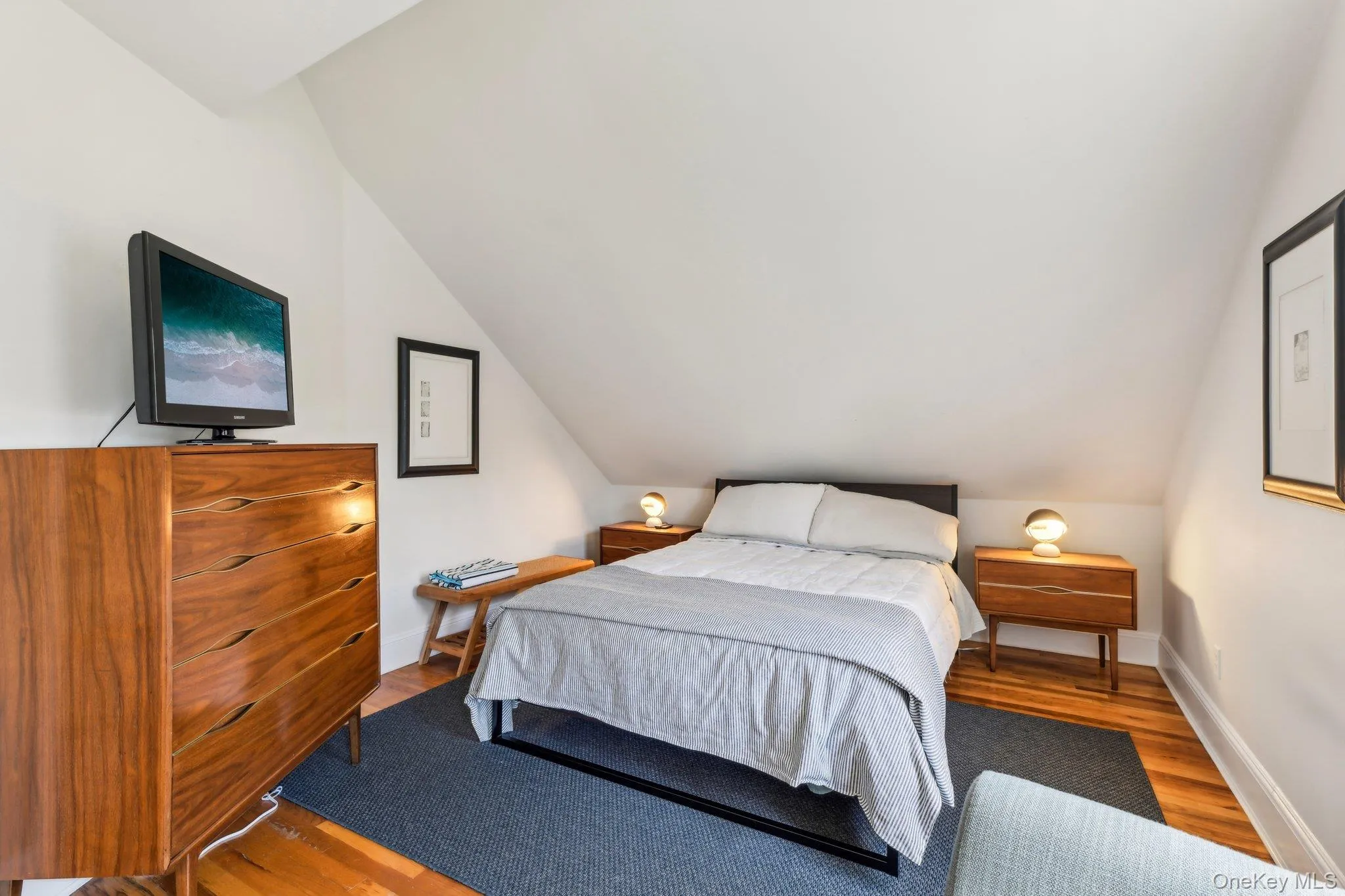 Bedroom with wood finished floors and lofted ceiling Bedroom with wood finished floors and lofted ceiling