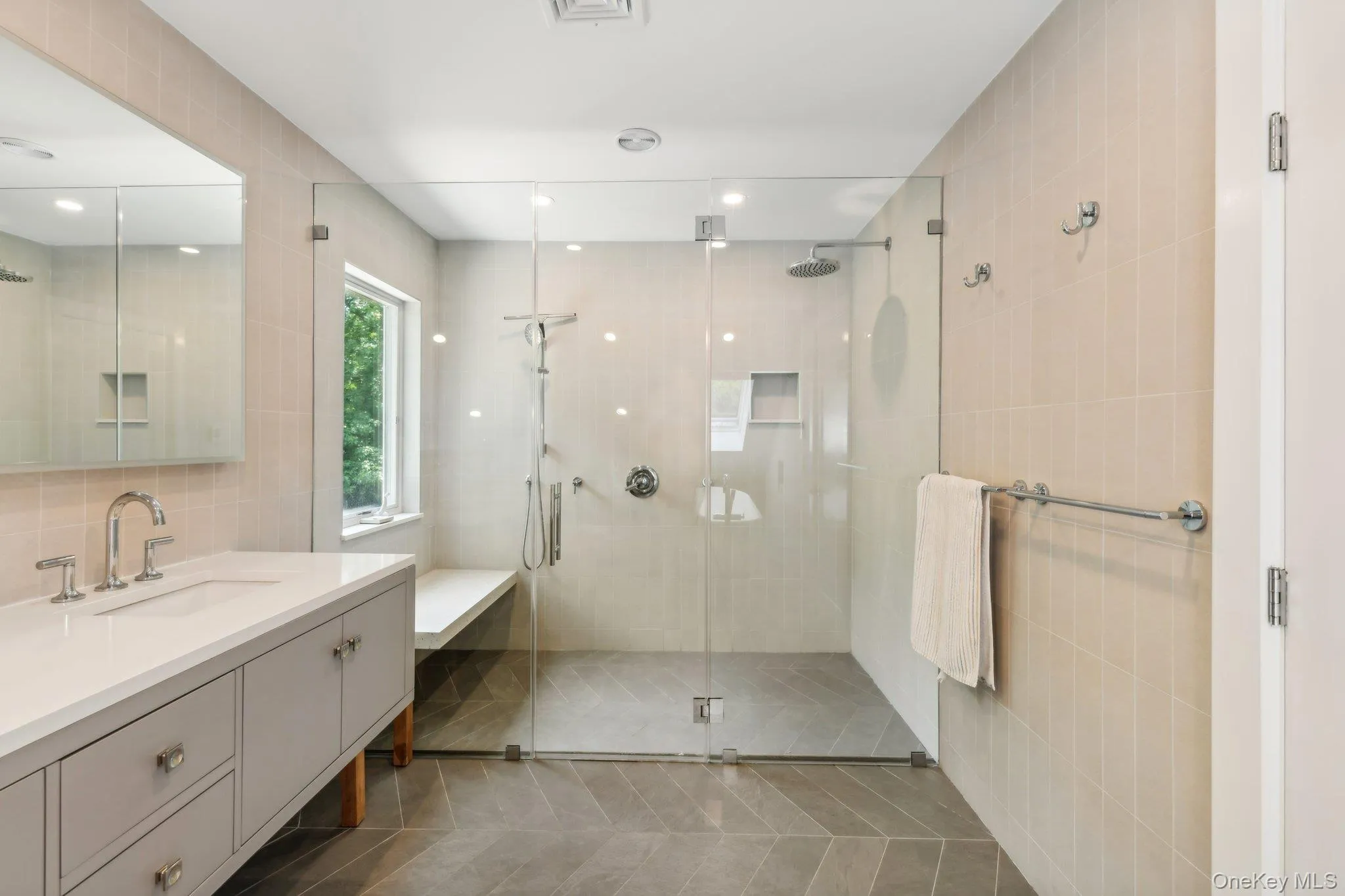 Bathroom featuring vanity, a stall shower, tile walls, tile patterned floors, and recessed lighting Bathroom featuring vanity, a stall shower, tile walls, tile patterned floors, and recessed lighting