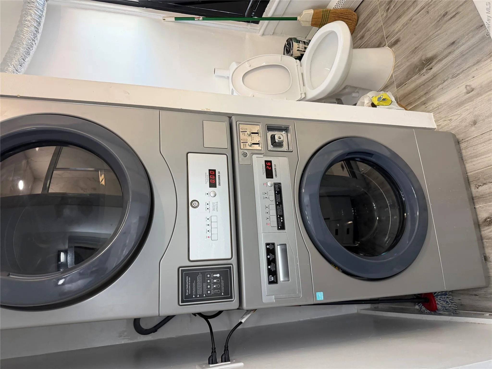 Stackable washer and dryer unit with front-loading design, digital controls, and a neutral finish Stackable washer and dryer unit with front-loading design, digital controls, and a neutral finish